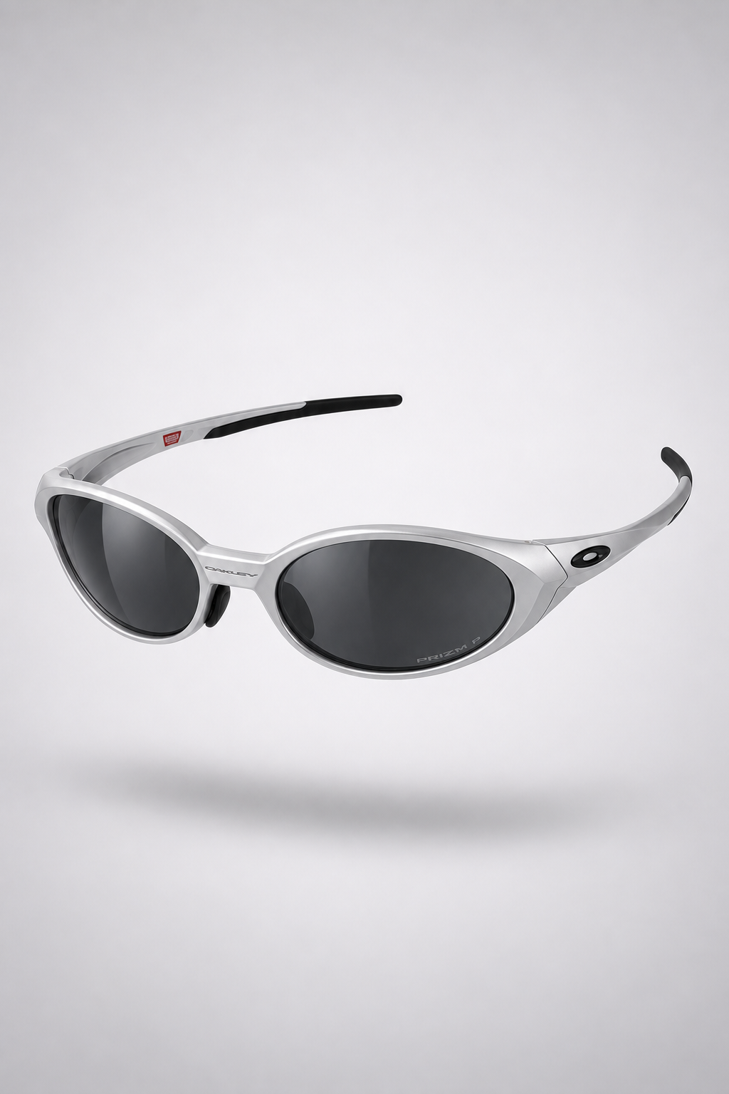 Oakley Eye Jacket Y2K — Silver / Black sunglasses, front three-quarter view on a light gray studio background